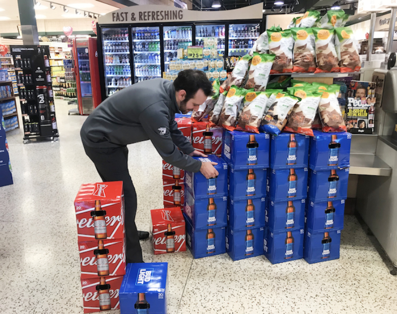 Grey Eagle member stacking beer